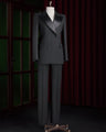 Women's black double-breasted tailored suit on a mannequin, featuring satin lapels and a structured fit, perfect for high-end formal events.
