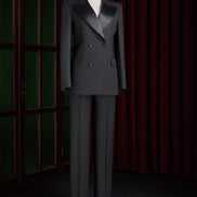 Women's black double-breasted tailored suit on a mannequin, featuring satin lapels and a structured fit, perfect for high-end formal events.