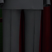 Close-up of women's black tailored suit pants and double-breasted blazer, showcasing sleek lines and luxury tailoring for a high-end formal look.