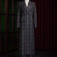 Women's double-breasted plaid overcoat in black, red, and white. Elegant formal wear crafted from sustainable materials, perfect for high-end style.