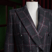 Close-up of black plaid women's overcoat with red and white accents, double-breasted design for formal wear, crafted with sustainable materials.