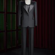Women's tailored black tuxedo suit with satin lapels, designed for formal events, showcasing high-end sustainable fashion and sophisticated elegance.