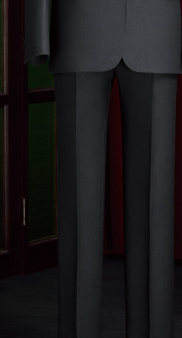 Close-up of women's black tailored tuxedo trousers, showcasing sharp crease lines and premium fabric for an elegant, high-end formal look.