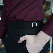 Close-up of men's tailored formal pants with adjustable side buckle, featuring eco-friendly fabric and refined design for a sophisticated, high-end look.