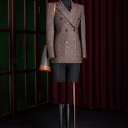 Women's double-breasted brown tweed blazer paired with black boots and a leather-accented bag, perfect for high-end formal occasions. Eco-friendly, sustainably crafted for style-conscious women seeking elegance and sophistication.