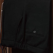 Close-up of black casual drawstring trousers with tailored detailing, designed for modern men seeking versatile, high-end fashion with sustainable appeal.