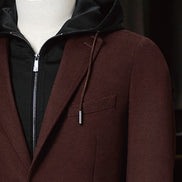 Close-up of men's burgundy blazer with peaked lapels and black hoodie underlayer, featuring a stylish blend of formal and casual elements. Perfect for eco-conscious shoppers seeking high-end, sustainable fashion with versatile appeal.