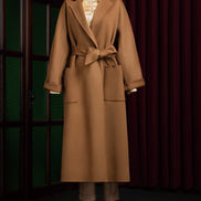 Elegant camel beige overcoat for women with tailored fit and belted waist, perfect for formal events. Sustainable, eco-friendly fashion in luxurious wool fabric.