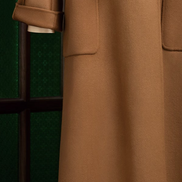 Detailed view of camel beige overcoat with rolled cuffs and spacious front pockets, crafted in luxurious wool fabric for a sophisticated, timeless look.