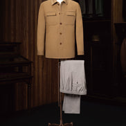 Luxurious camel-colored tailored jacket paired with elegant grey trousers, designed for a high-end look at formal events. Crafted with eco-friendly, sustainable materials, this stylish men's outfit combines sophistication and comfort, perfect for refined fashion enthusiasts.