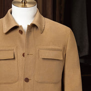 Close-up of camel tailored jacket, featuring sleek chest pockets and a refined collar design, crafted from eco-friendly materials for a high-end look