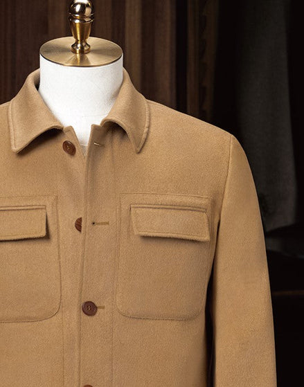 Close-up of camel tailored jacket, featuring sleek chest pockets and a refined collar design, crafted from eco-friendly materials for a high-end look