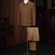 Men's camel tailored jacket with matching trousers, elegantly displayed on a mannequin. Sustainable, high-end fabric for eco-conscious formal wear. Ideal for sharp, refined looks.