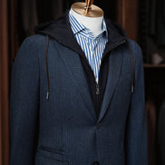 Close-up of a navy tailored blazer with hoodie details and blue striped shirt, showcasing modern tailoring by POLLHEIM. Ideal for casual yet refined fashion styles.