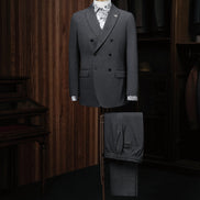 Elegant charcoal grey double-breasted suit on a mannequin, showcasing high-end tailoring for men. Perfect for formal events, crafted with sustainable materials.