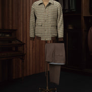 Checked field jacket paired with brown khaki trousers on a mannequin, showcasing eco-friendly, high-end tailoring for women, perfect for formal elegance.