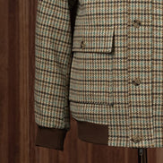 Close-up of a checked field jacket pocket and sleeve, highlighting eco-friendly tailored details and premium textured fabric, perfect for formal wear.