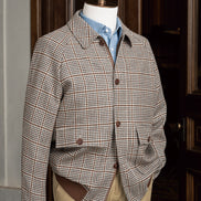 Close-up of a tailored houndstooth sports coat paired with chinos, showcasing sustainable fabric and fine detailing, ideal for formal and eco-conscious style.