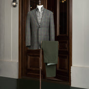 Tailored checked wool jacket paired with olive trousers on a mannequin, showcasing sustainable, high-end fashion perfect for formal elegance and eco-conscious style.