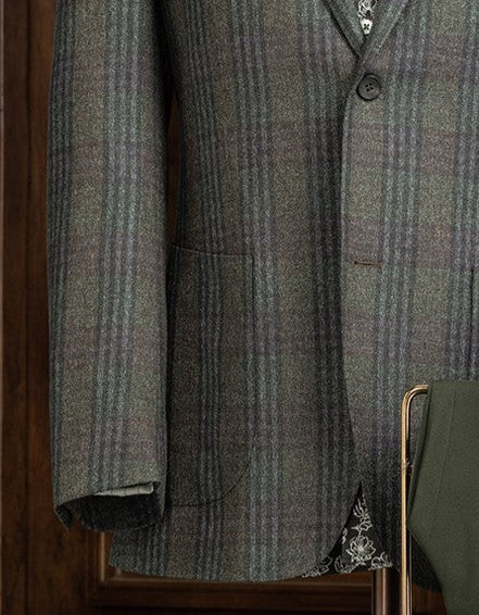 Close-up of checked wool jacket sleeve and pocket, showcasing fine tailoring and sustainable fabric, perfect for a sophisticated, eco-friendly style.