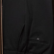 Close-up of black tailored trousers, showcasing premium fabric and precise detailing, perfect for formal, eco-conscious fashion.