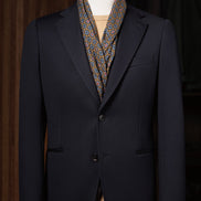 Close-up of a classic navy blazer with structured peak lapels and sleek pocket details. Perfect for a high-end, polished look for formal events.