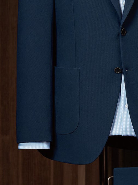 Close-up of expertly crafted buttons and pockets on a navy suit jacket, designed for women seeking high-end, sustainable formalwear with a touch of sophistication