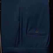 Close-up of classic navy suit trousers featuring precision tailoring and a sleek pocket detail, embodying elegance and eco-conscious fashion for formal occasions