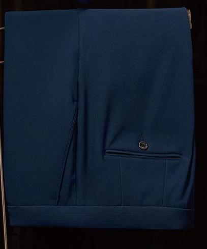 Close-up of classic navy suit trousers featuring precision tailoring and a sleek pocket detail, embodying elegance and eco-conscious fashion for formal occasions