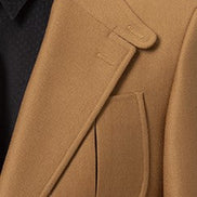 Highlighting the expertly crafted peak lapel and pocket details on a dark beige safari suit, designed with sustainable materials for a luxurious, eco-friendly formal outfit.