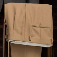 Elegant beige tailored trousers with side adjusters, highlighting premium craftsmanship and meticulous stitching. Ideal for refined formalwear.