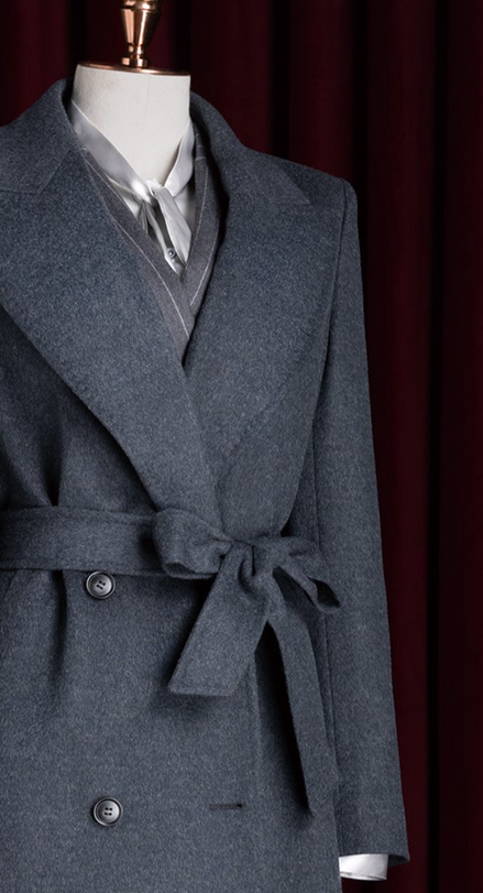Detailed view of a dark grey overcoat's upper section, highlighting wide lapels and a sophisticated tie-front closure, designed for luxurious warmth and style.