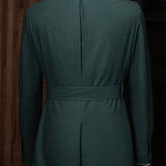 Rear view of the green suit jacket, revealing a structured belt detail that enhances the silhouette, embodying sophistication with eco-conscious design.