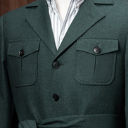 A close-up of the jacket’s chest pockets with button detailing, demonstrating elegant craftsmanship and sustainable tailoring perfect for discerning customers.