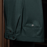 Detailed view of the green suit trousers, highlighting buttoned side tabs and refined stitching, crafted with eco-friendly practices for a luxurious feel.