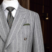 Close-up of a light grey double-breasted suit, featuring refined lapels, and a flattering clean white shirt, ideal for formal wear.