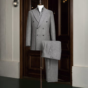 Elegant grey double-breasted suit on a mannequin, showcasing high-end tailoring for men. Perfect for formal events, crafted with sustainable materials.
