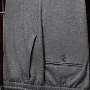 Close-up of wool suit trousers, showcasing fine textured fabric, precise tailoring, and back pocket detail, perfect for a sophisticated formal look.