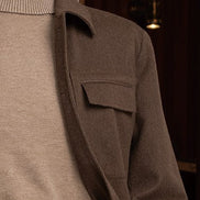 Close-up of a earthy brown jacket and matching cargos, paired with a beige turtleneck and for a refined, high-end look.
