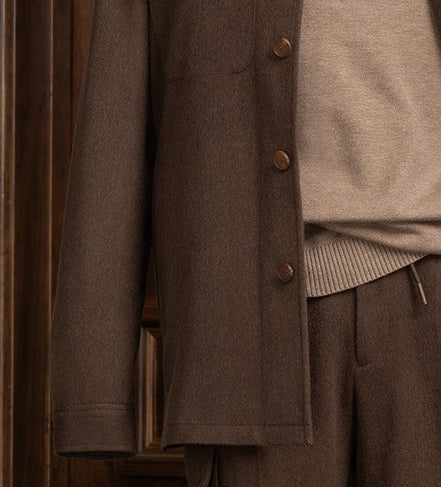 Close-up view of an earthy brown jacket and cargos, showcasing fine tailoring and sophisticated style for formal occasions.