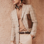 Checked suit blazer paired with beige tailored trousers on a mannequin, showcasing eco-friendly, high-end tailoring for men, perfect for formal elegance.