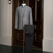 A sophisticated grey houndstooth blazer paired with black trousers, perfect for both formal and semi-formal occasions.