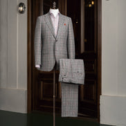 A distinguished grey plaid suit on display, featuring a refined design suitable for business and formal events.