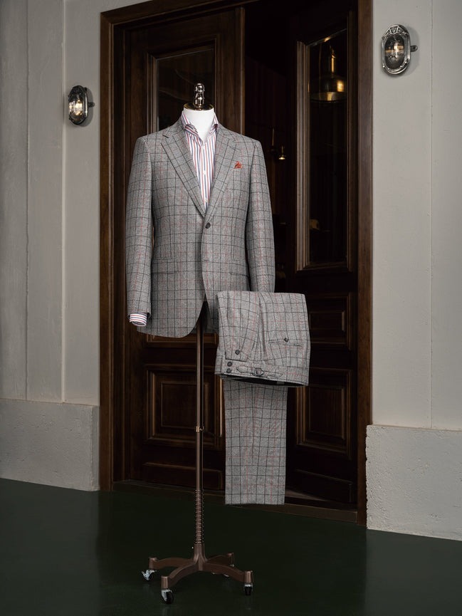 A distinguished grey plaid suit on display, featuring a refined design suitable for business and formal events.