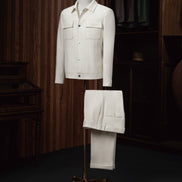 The Couturist's matching white tailored jacket and trousers ensemble on display. Premium women's formalwear featuring sustainable materials.