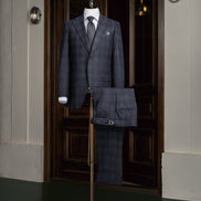 A stylish navy checked suit displayed on a mannequin, featuring a classic design perfect for formal and professional occasions