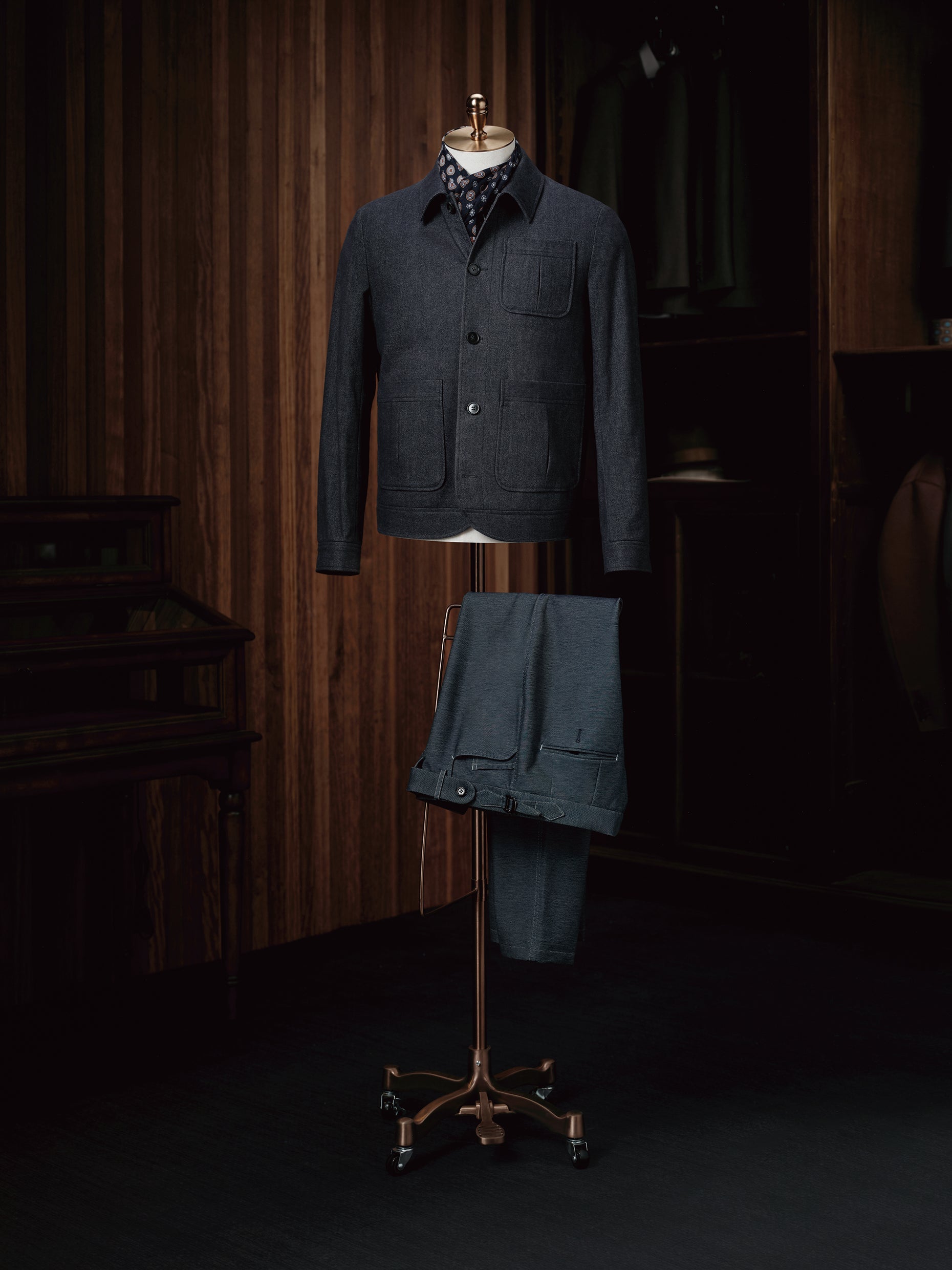 A sophisticated navy wool overshirt paired with navy trousers, perfect for a seamless and elegant look.