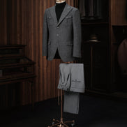 A refined textured wool jacket paired with pleated trousers, ideal for a sophisticated and contemporary look.