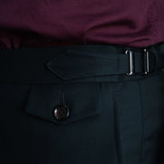 Close-up of men's tailored formal pants with side buckle adjuster and buttoned pocket flap, crafted for a refined and high-end formal look.